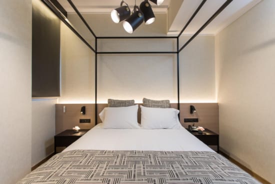 a bed with a large mirror above it