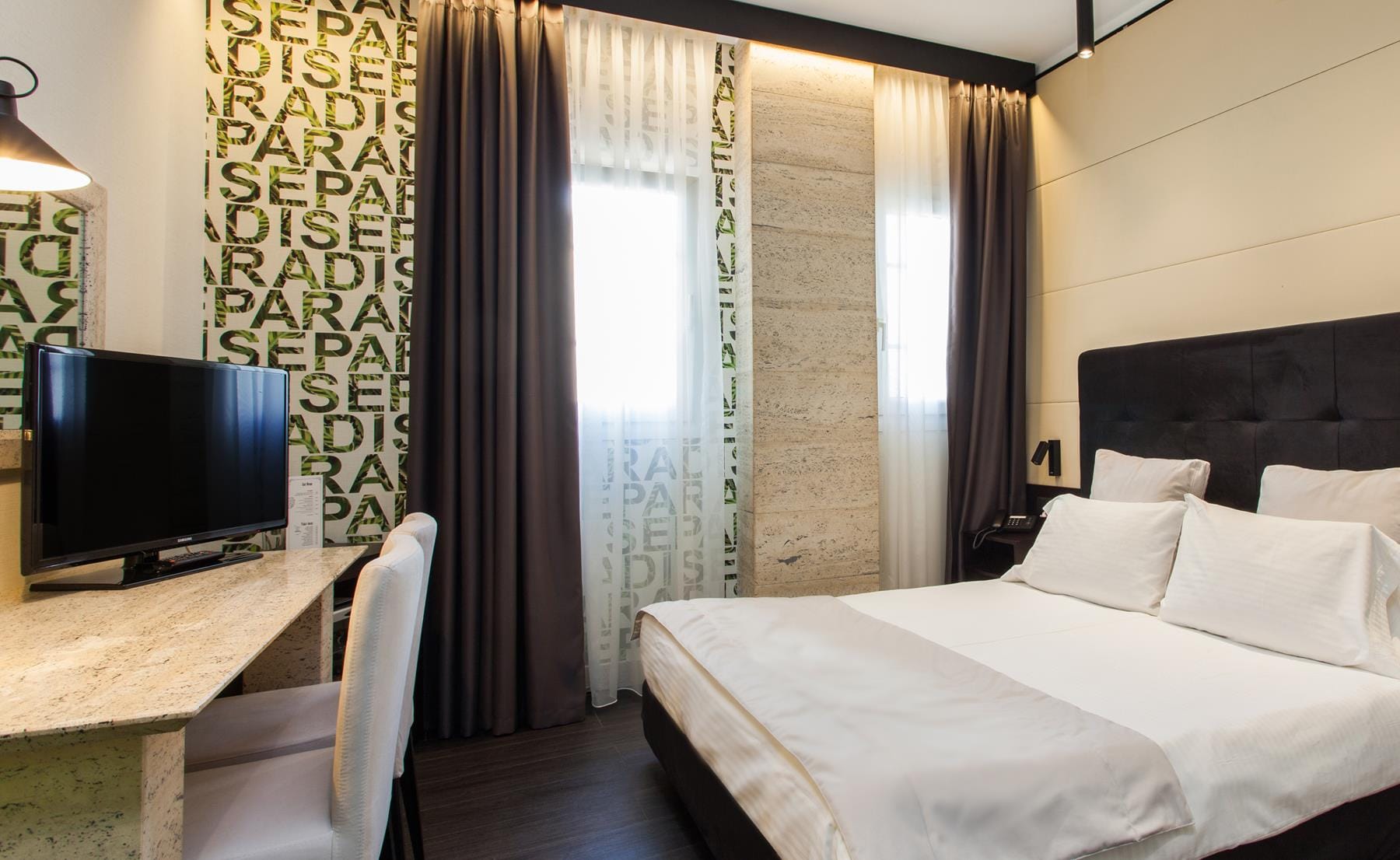 a bedroom with a bed and a tv