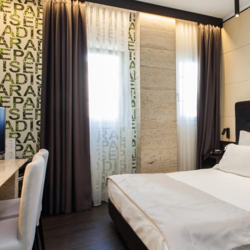a bedroom with a bed and a tv