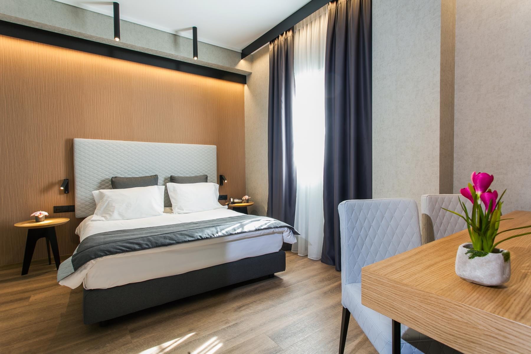 a bedroom with a bed and chairs