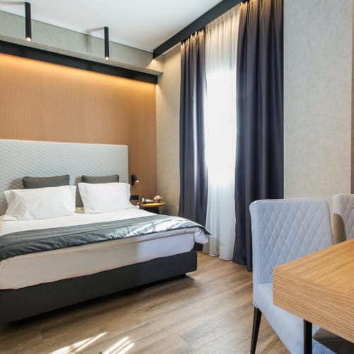 a bedroom with a bed and chairs