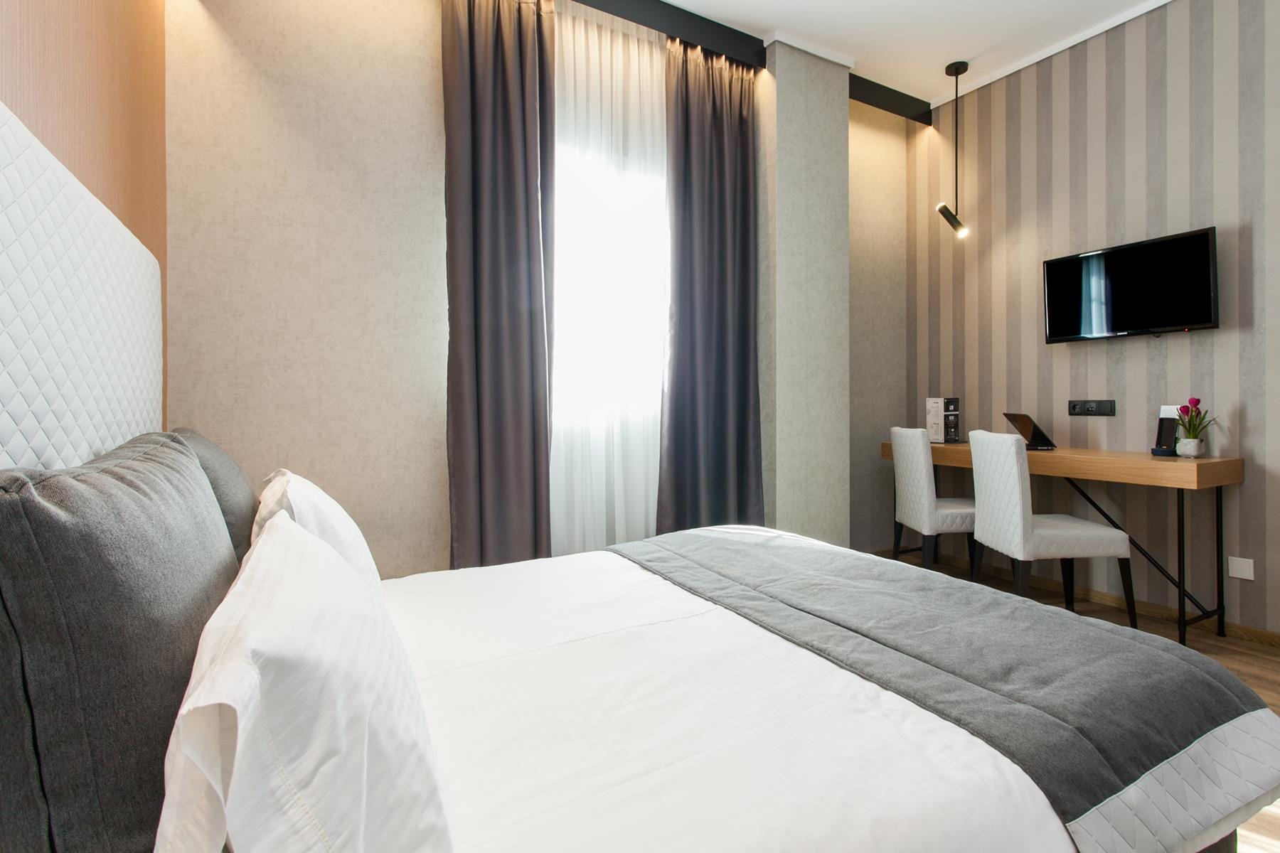 a hotel room with a bed and a desk