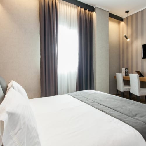 a hotel room with a bed and a desk