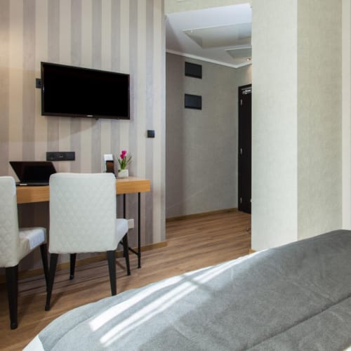 a room with a tv and chairs