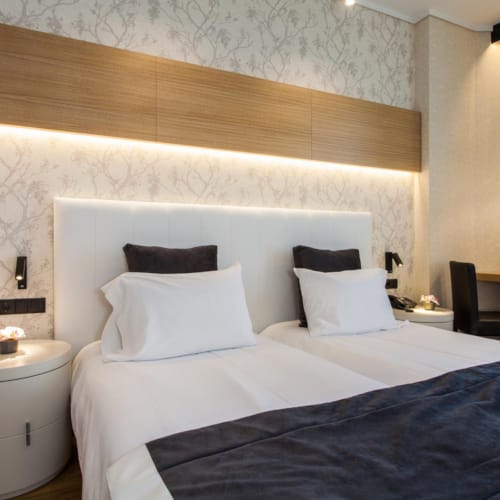 a bed with a white headboard