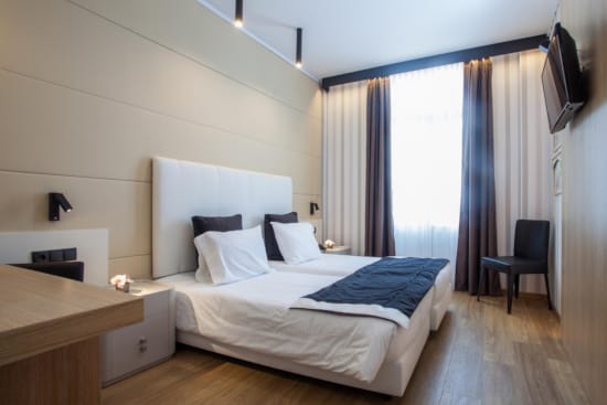 a bedroom with a bed and a chair