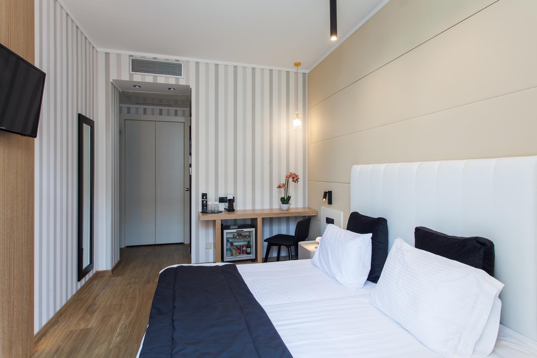 a bedroom with a bed and a desk