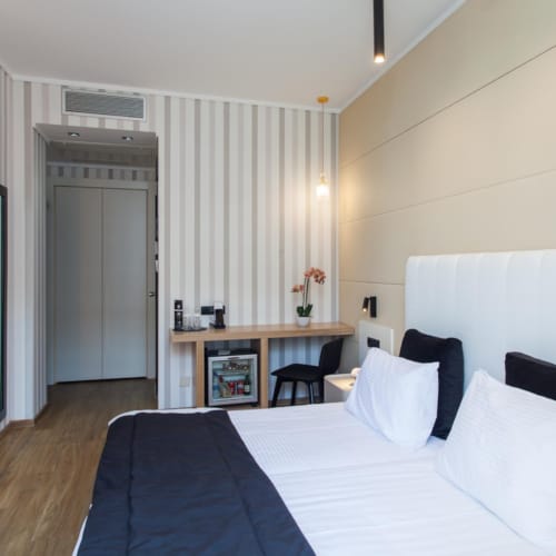 a bedroom with a bed and a desk