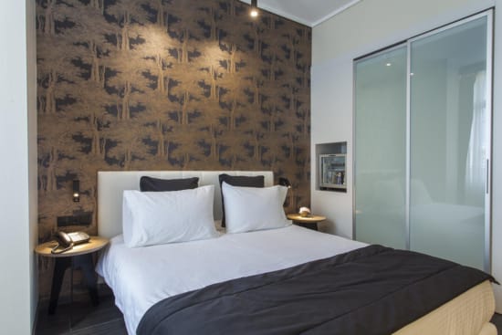 a bed with a black and white comforter