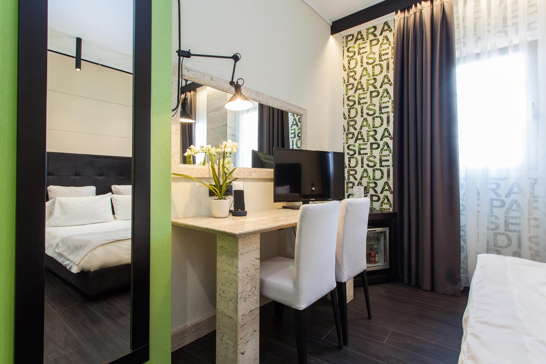 a room with a desk and a bed