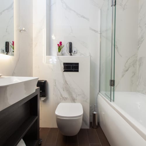a bathroom with a tub toilet and sink