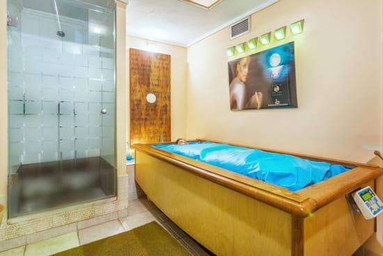 a room with a bed and a tv on the wall