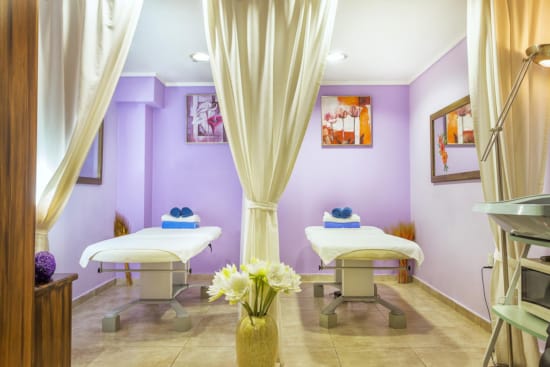 a room with a couch and a table with flowers