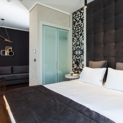 a bedroom with a bed and a bench