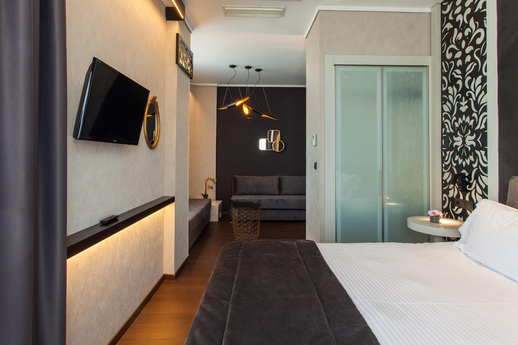 a bedroom with a bed and a tv