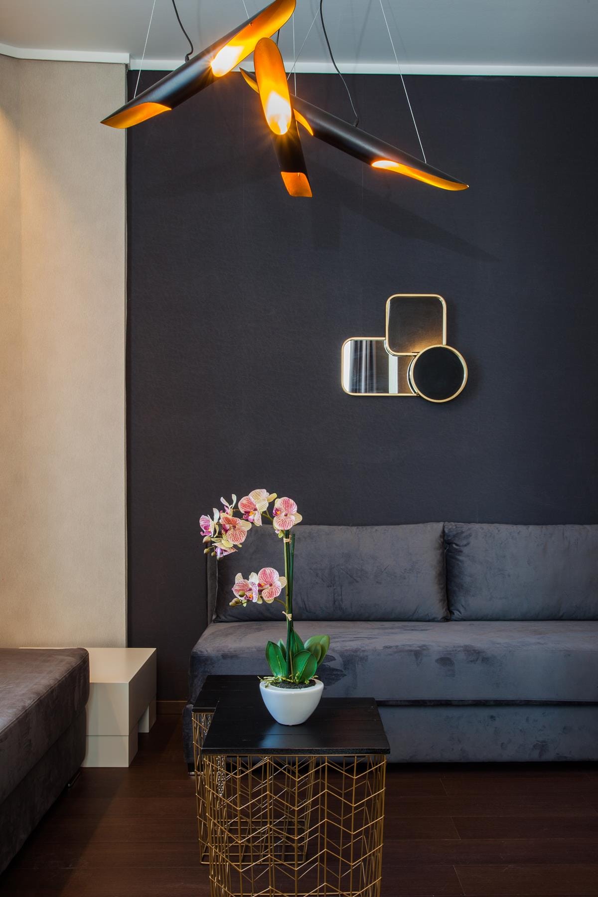 a room with a couch and a table with a plant on it