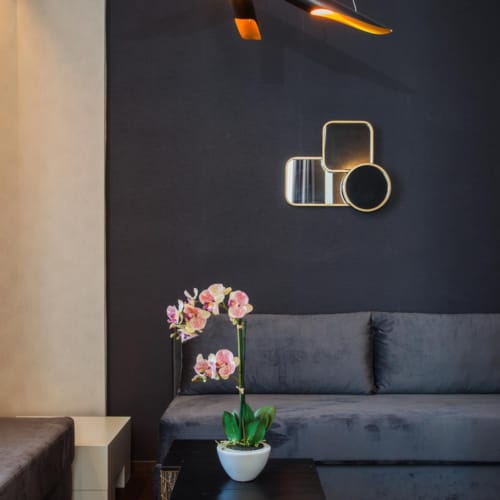 a room with a couch and a table with a plant on it