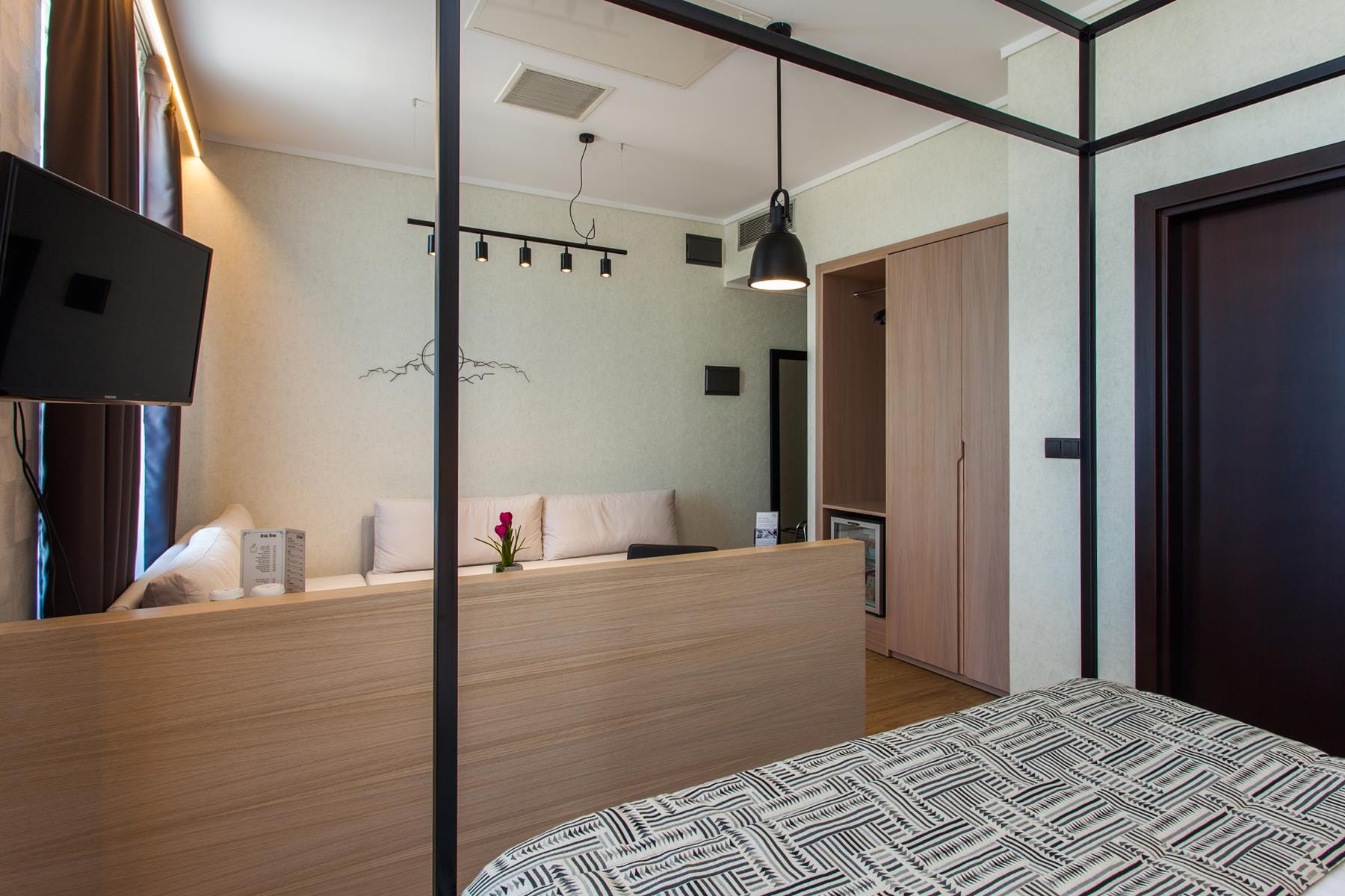 a room with a bed and a tv