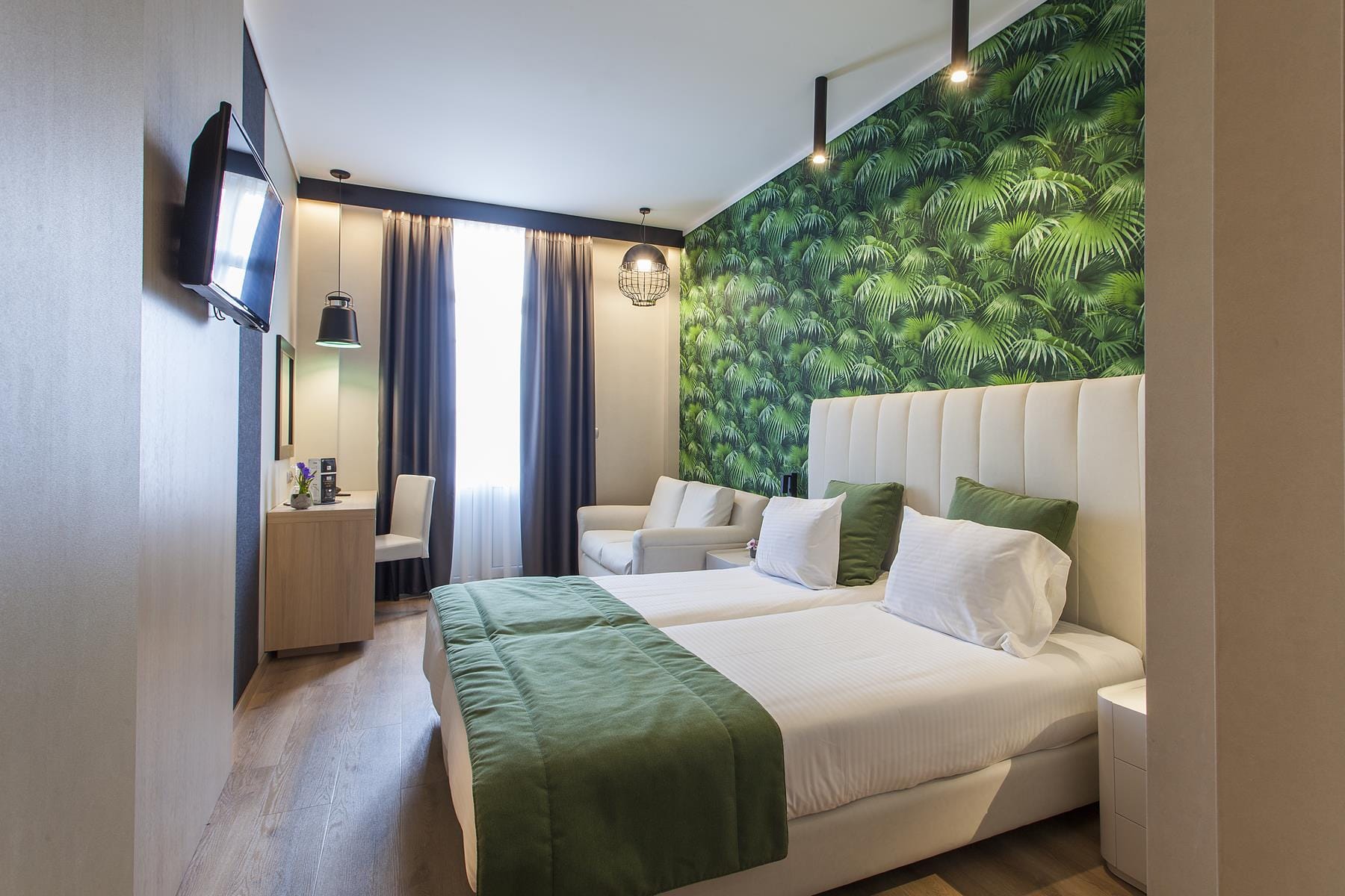 a hotel room with a bed and a tv