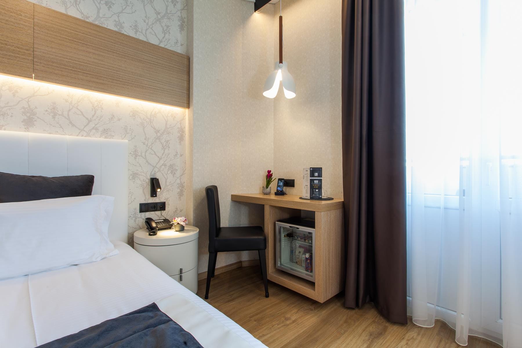 a bedroom with a bed desk and a chair