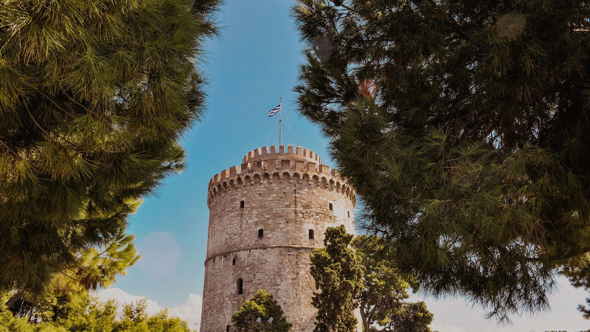 a tall tower with trees around it