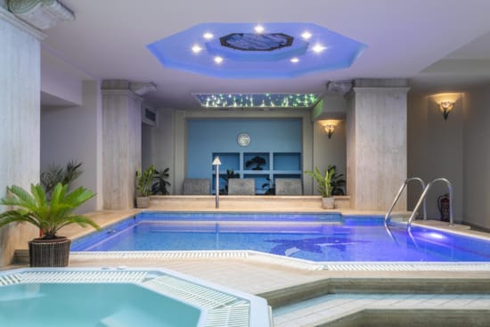a swimming pool with a large blue ceiling and white walls