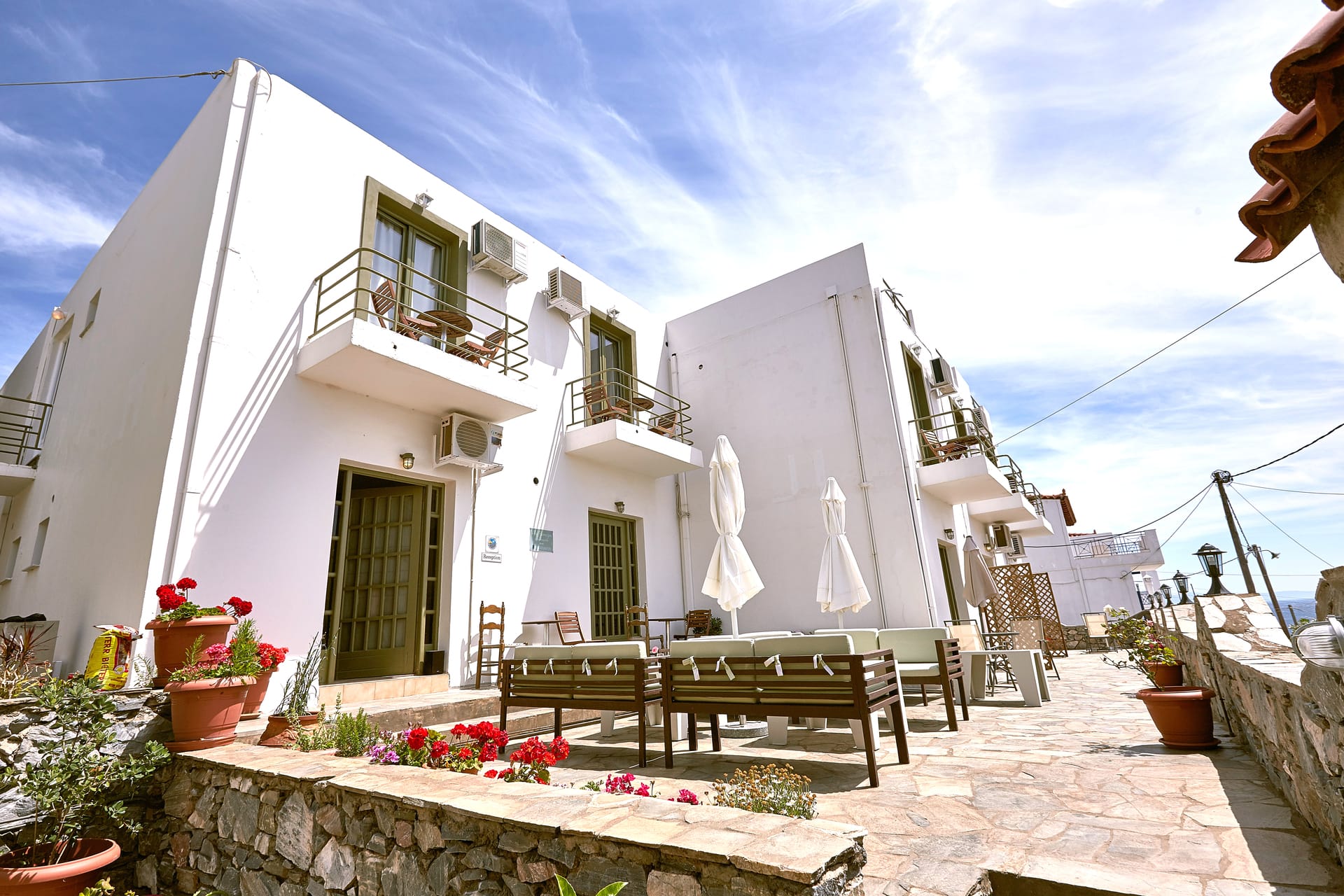 a white building with a bench in front of it