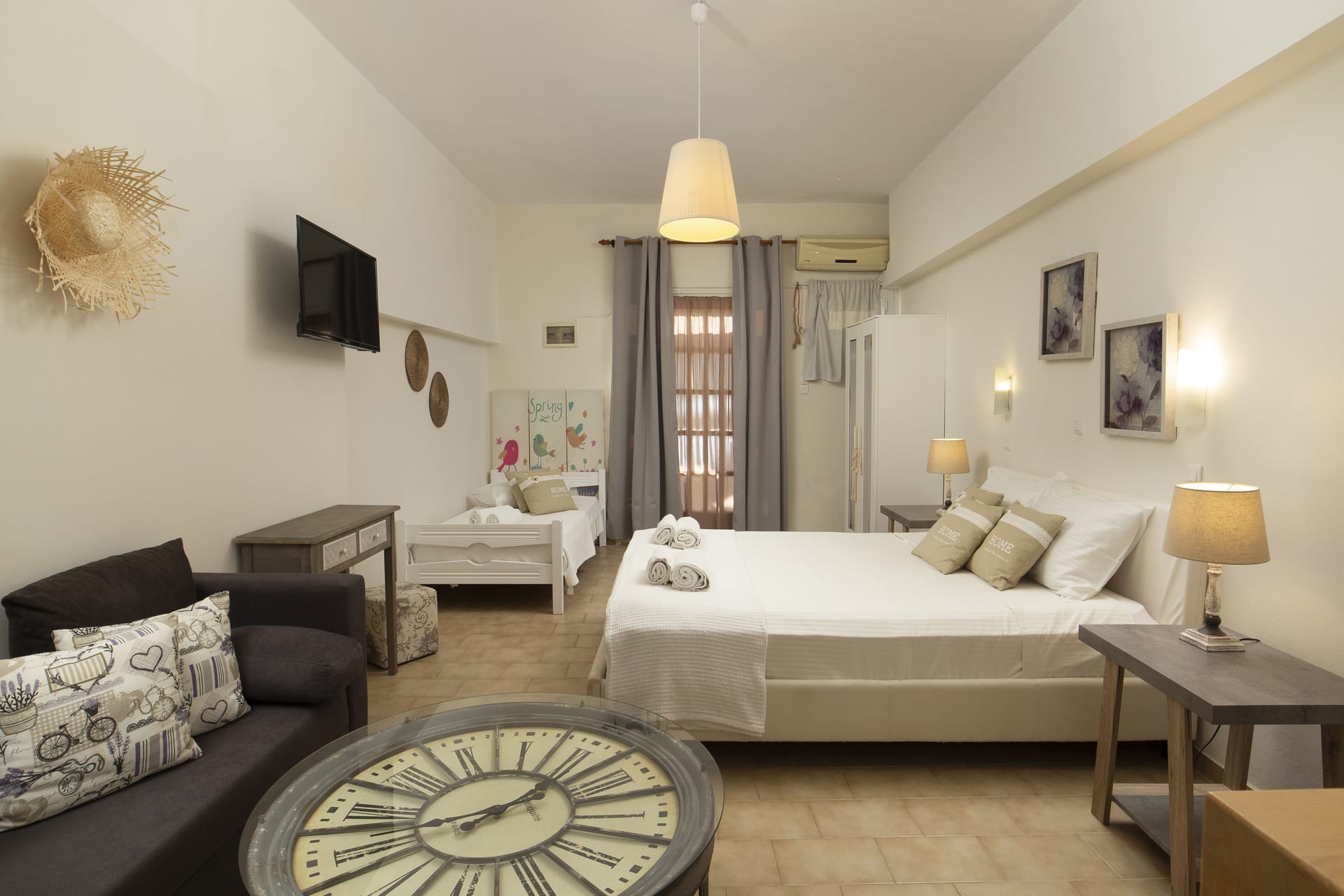 a bedroom with a bed and couches