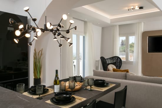 a dining room table with a chandelier above it