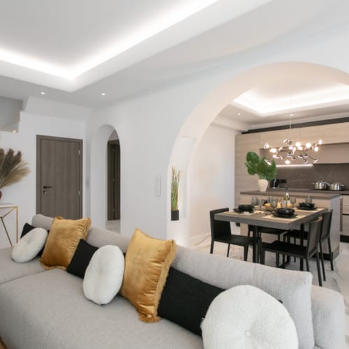 a living room with a couch and a dining table