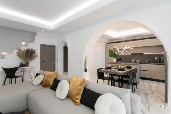 a living room with a couch and a dining table