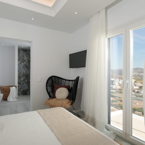 a bedroom with a bed and a chair