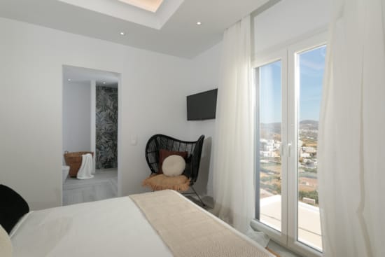 a bedroom with a bed and a chair