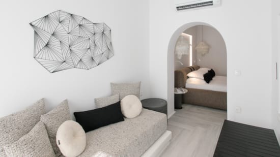 a room with a couch and a mirror