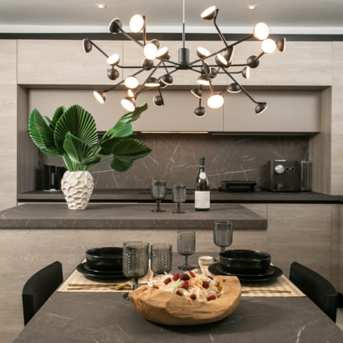a kitchen with a large chandelier over the island