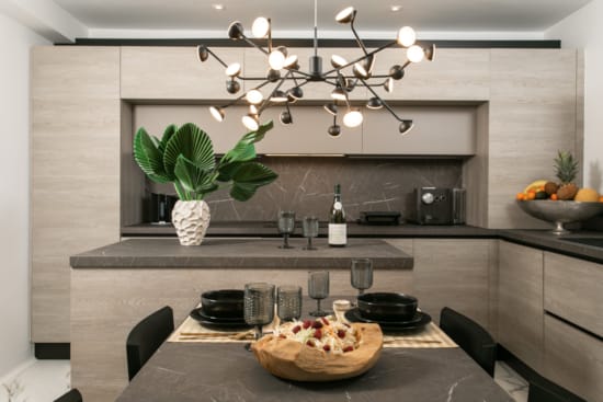 a kitchen with a large chandelier over the island