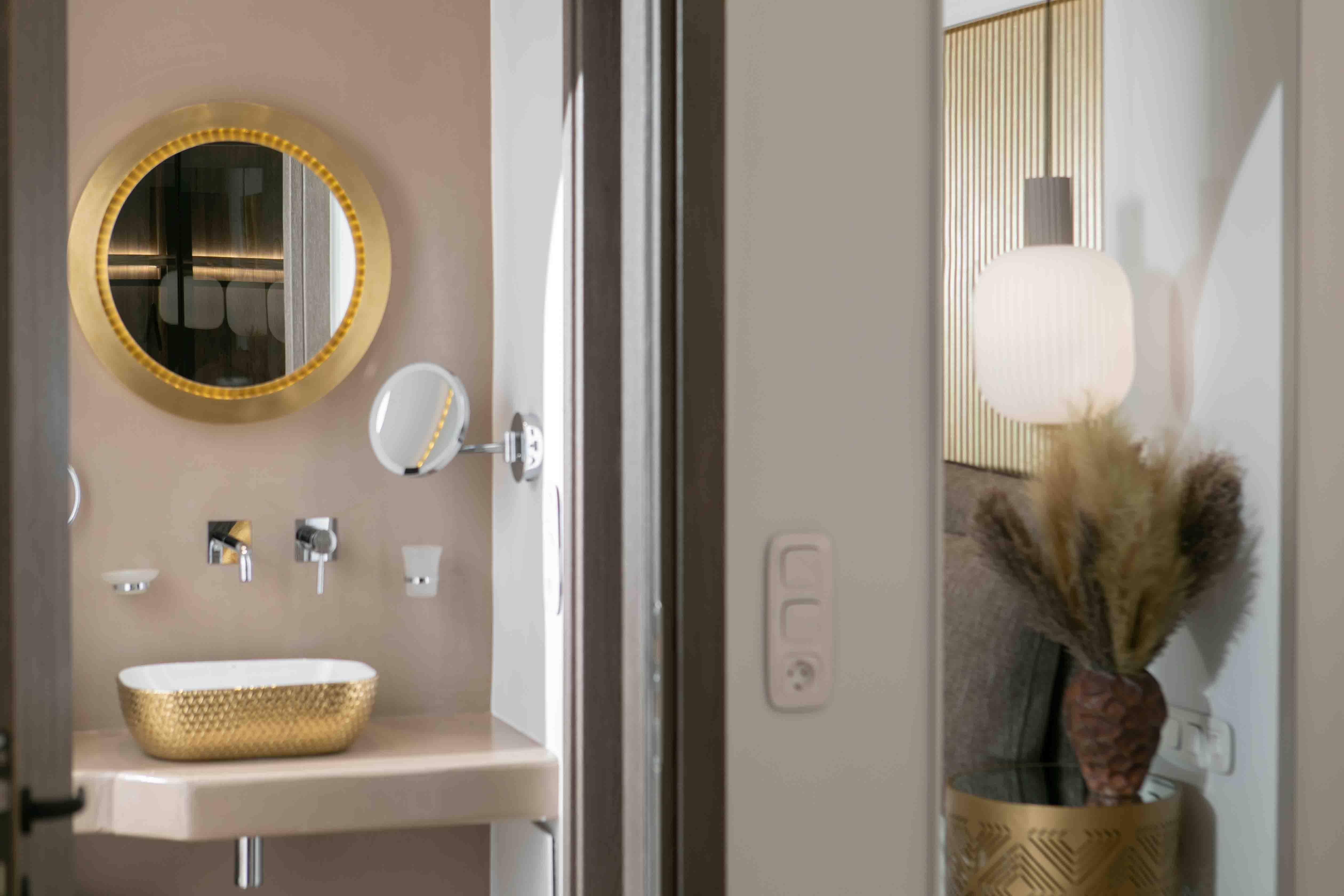 a bathroom with a mirror and a plant