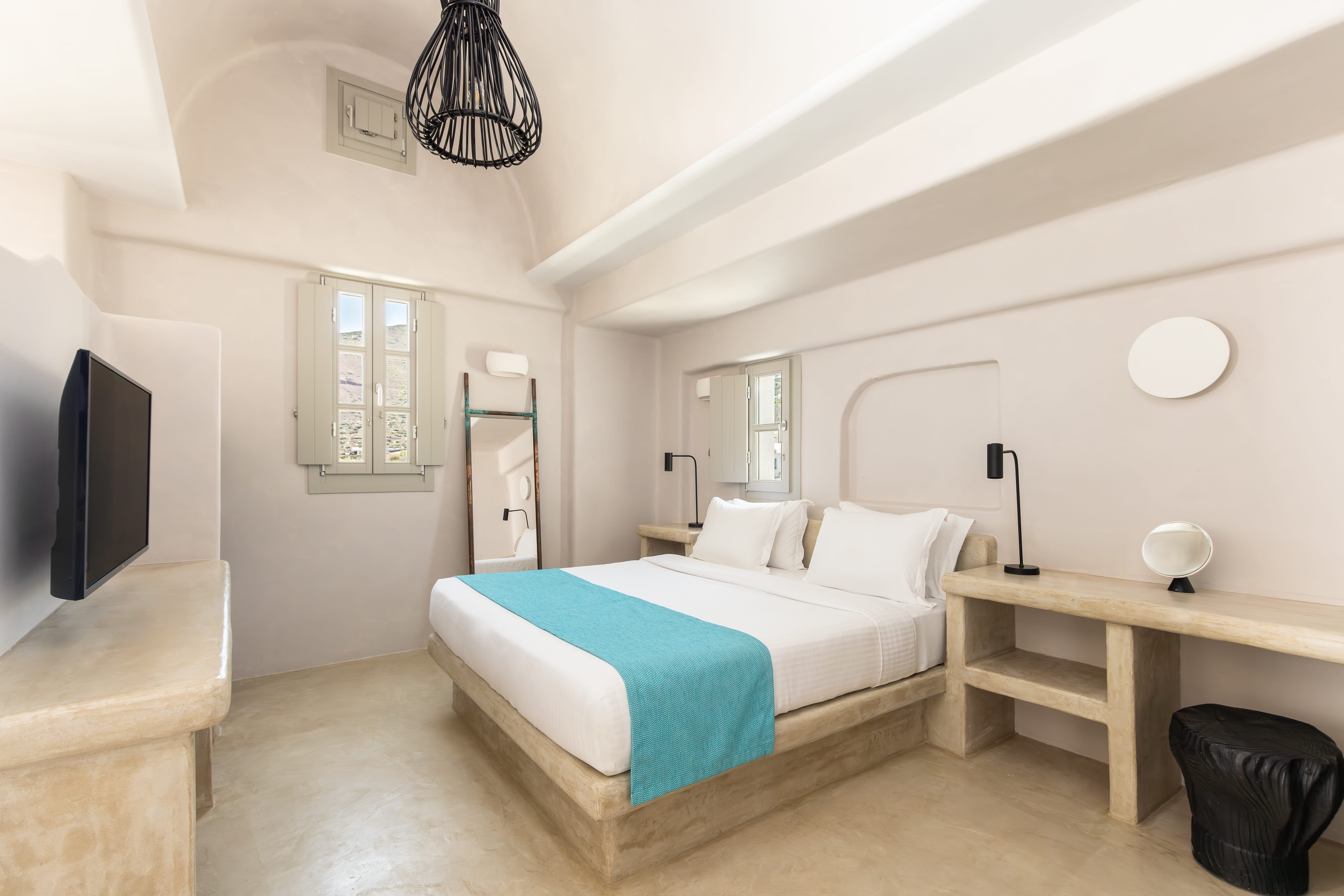 a bedroom with a bed and a tv