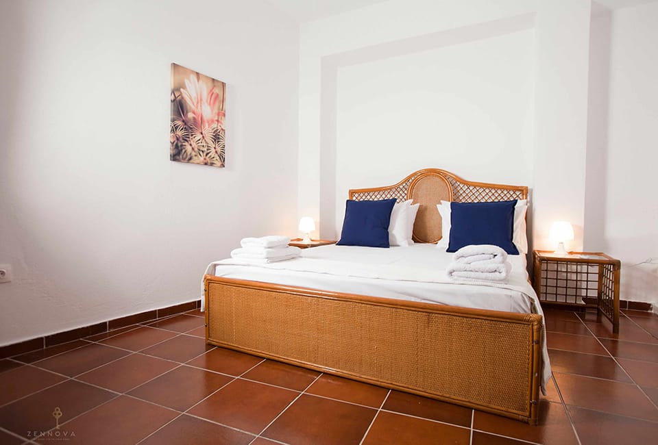 a bed with blue pillows