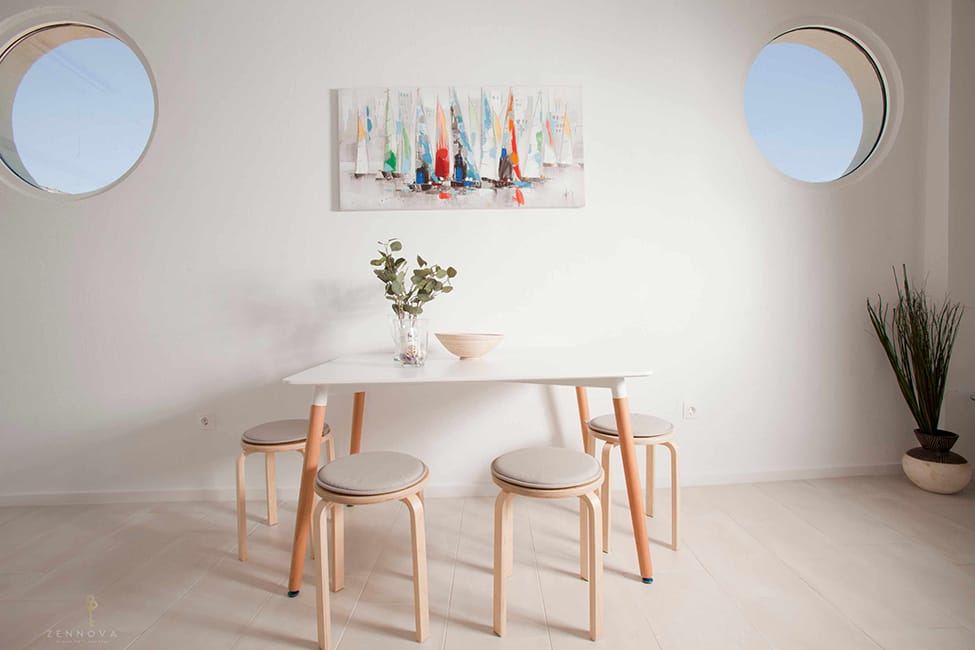 a table with stools and a plant on it