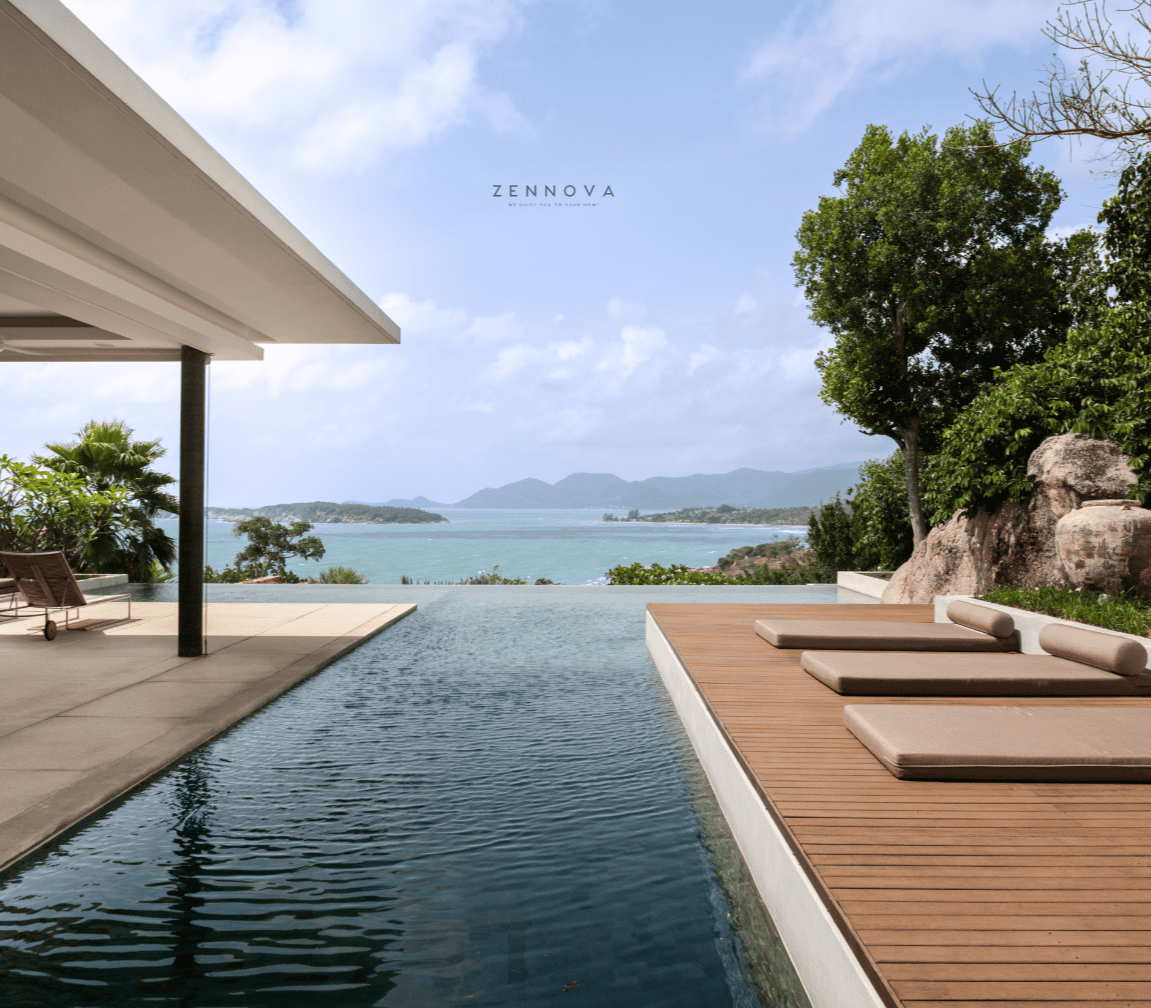 a pool with a deck and a view of the ocean