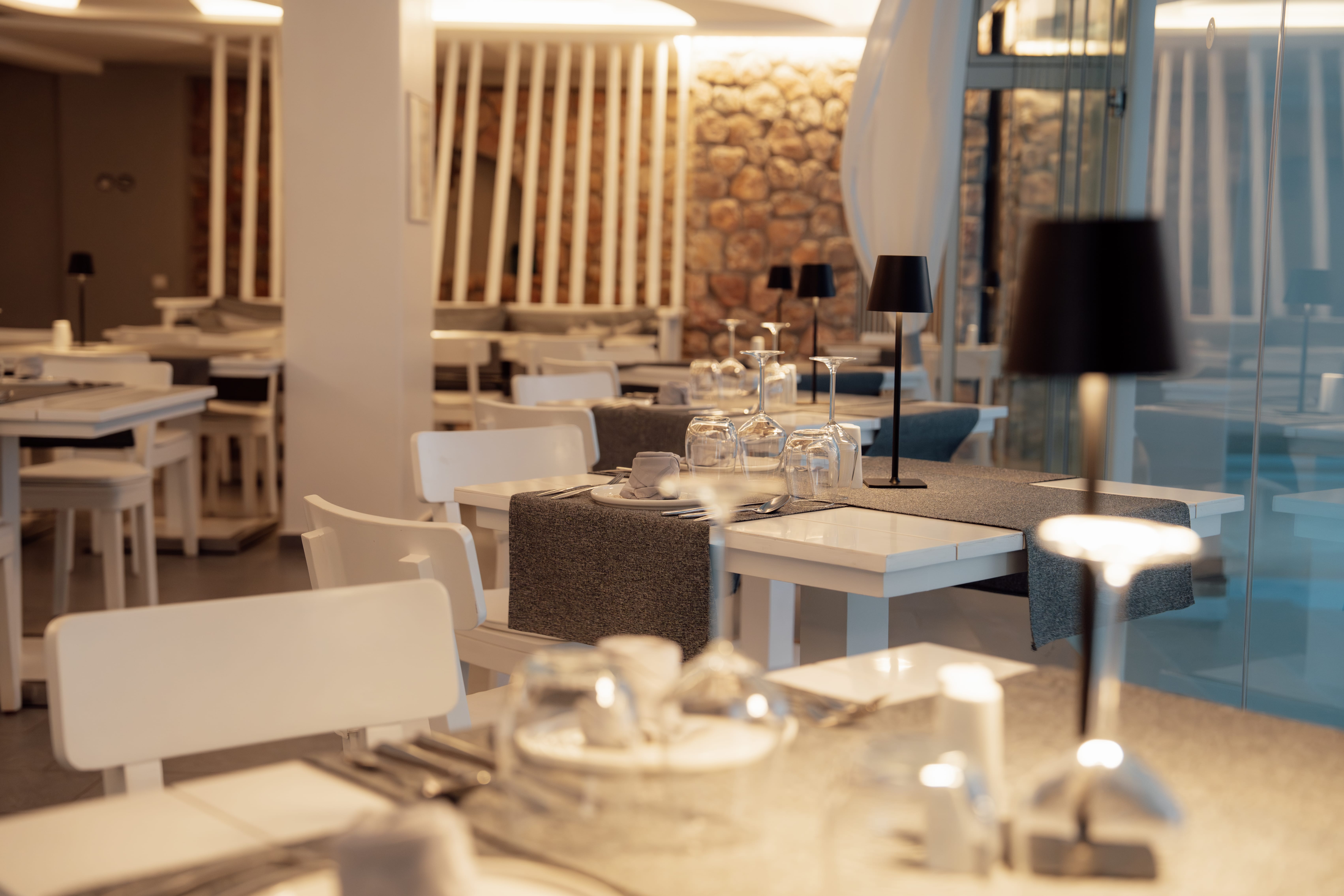 a room with white chairs and tables