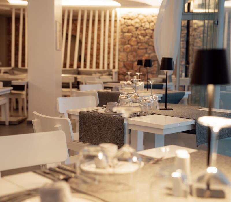 a room with white chairs and tables