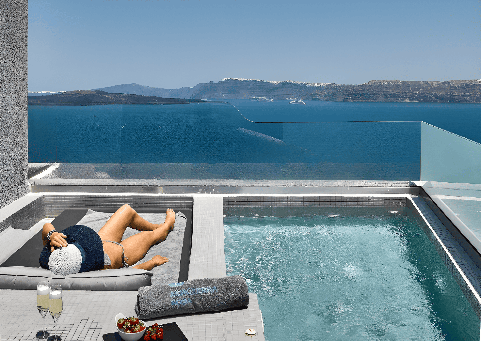 a person lying on a chair by a pool