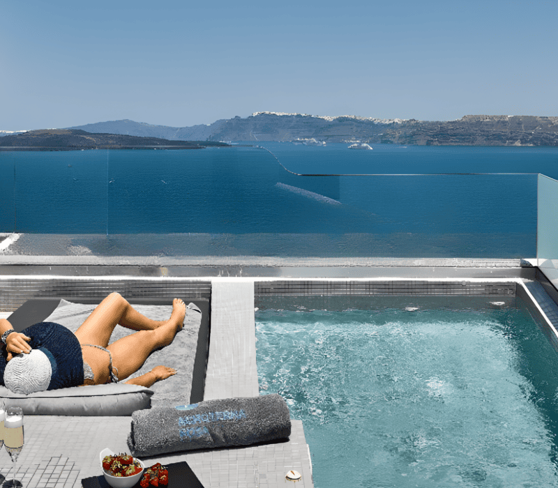 a person lying on a chair by a pool