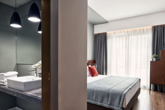 a bedroom with a bed and a bathtub