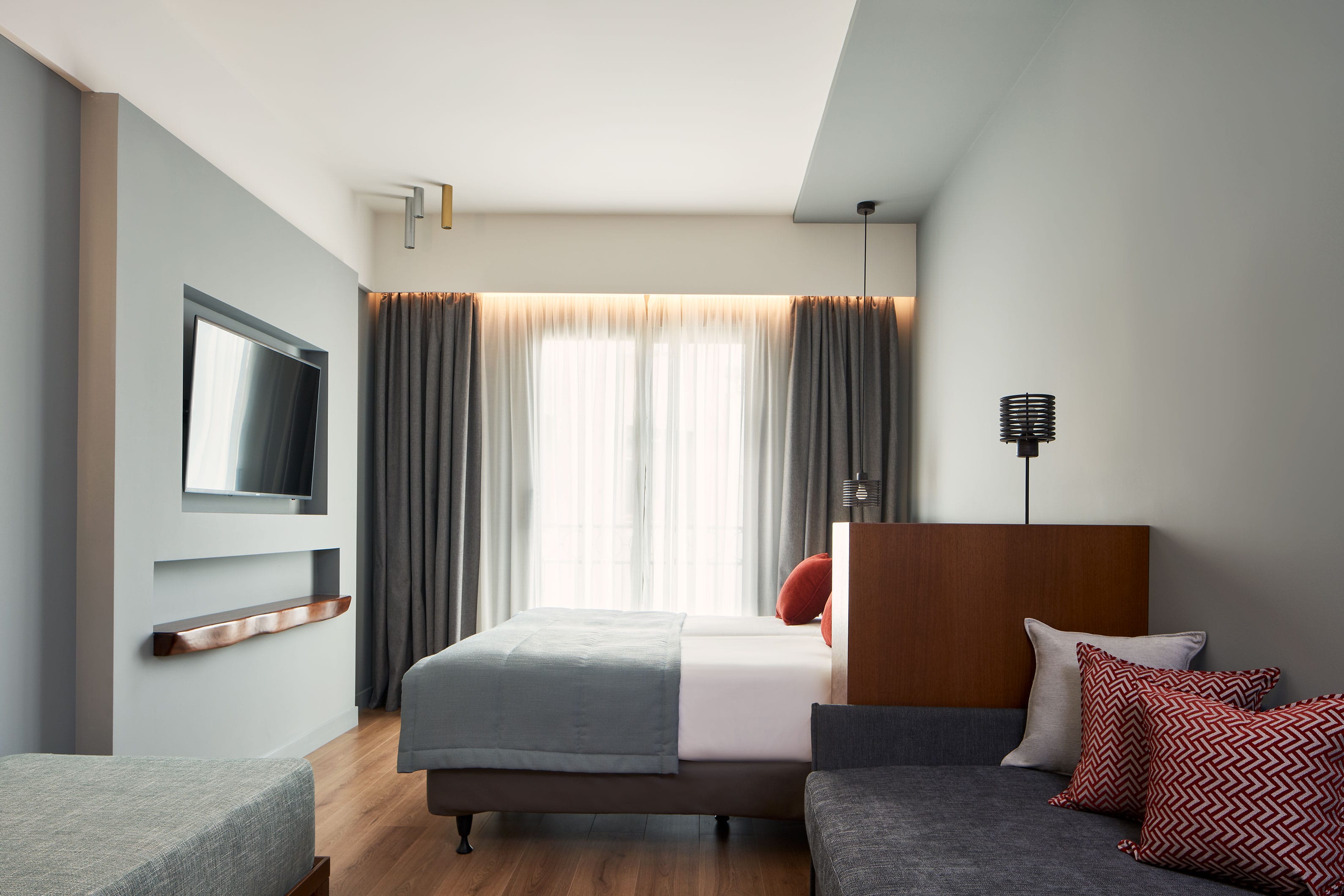 a room with a bed and a tv