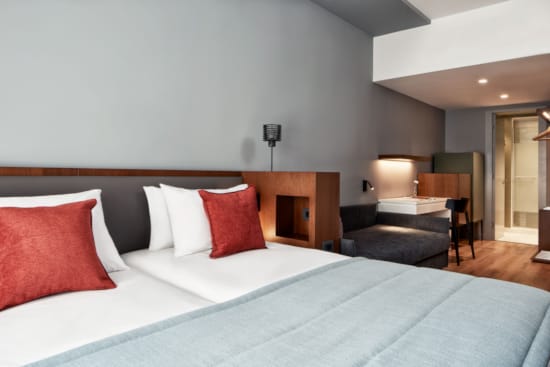 a bed with red pillows