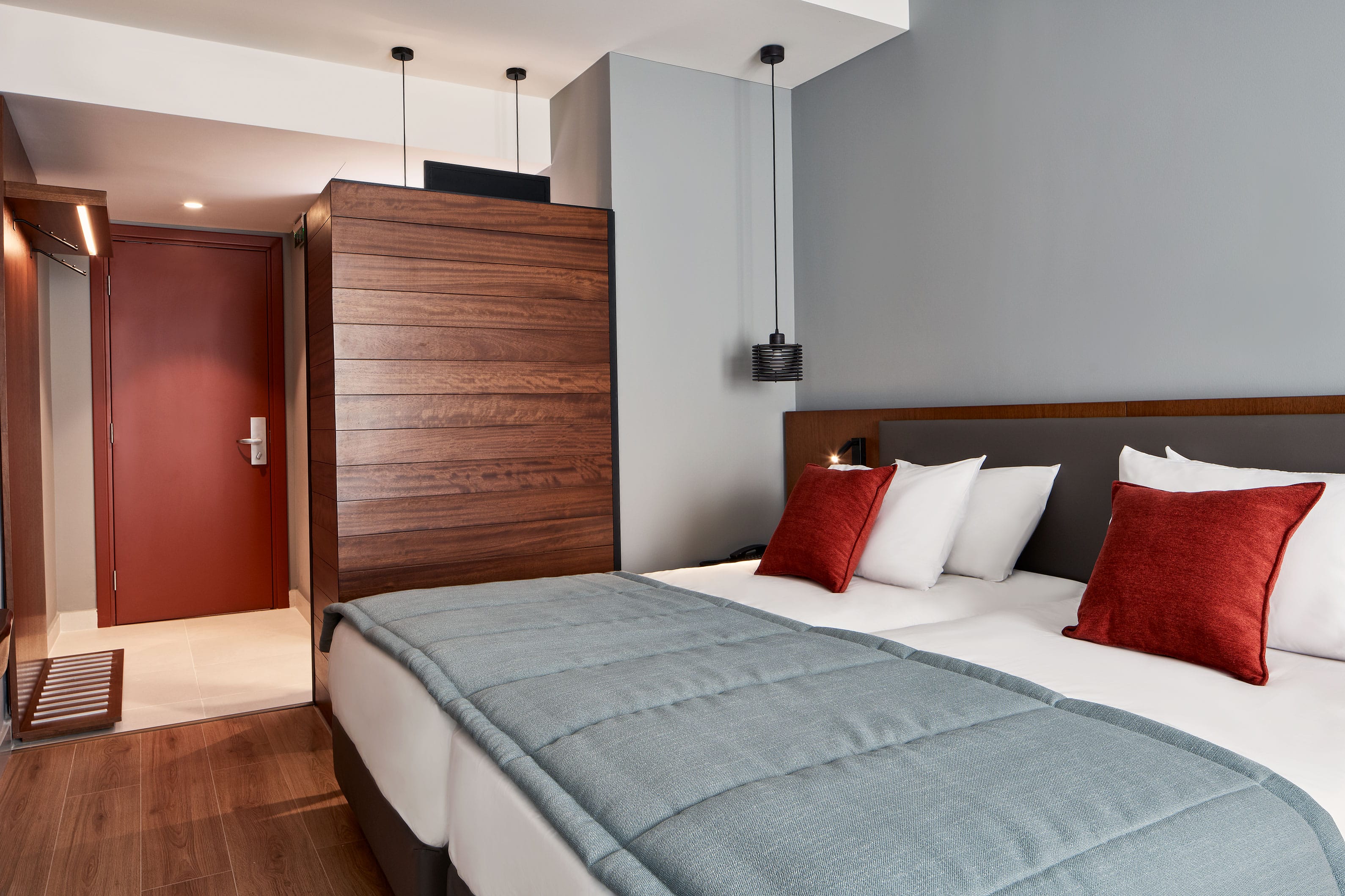 a bed with red pillows