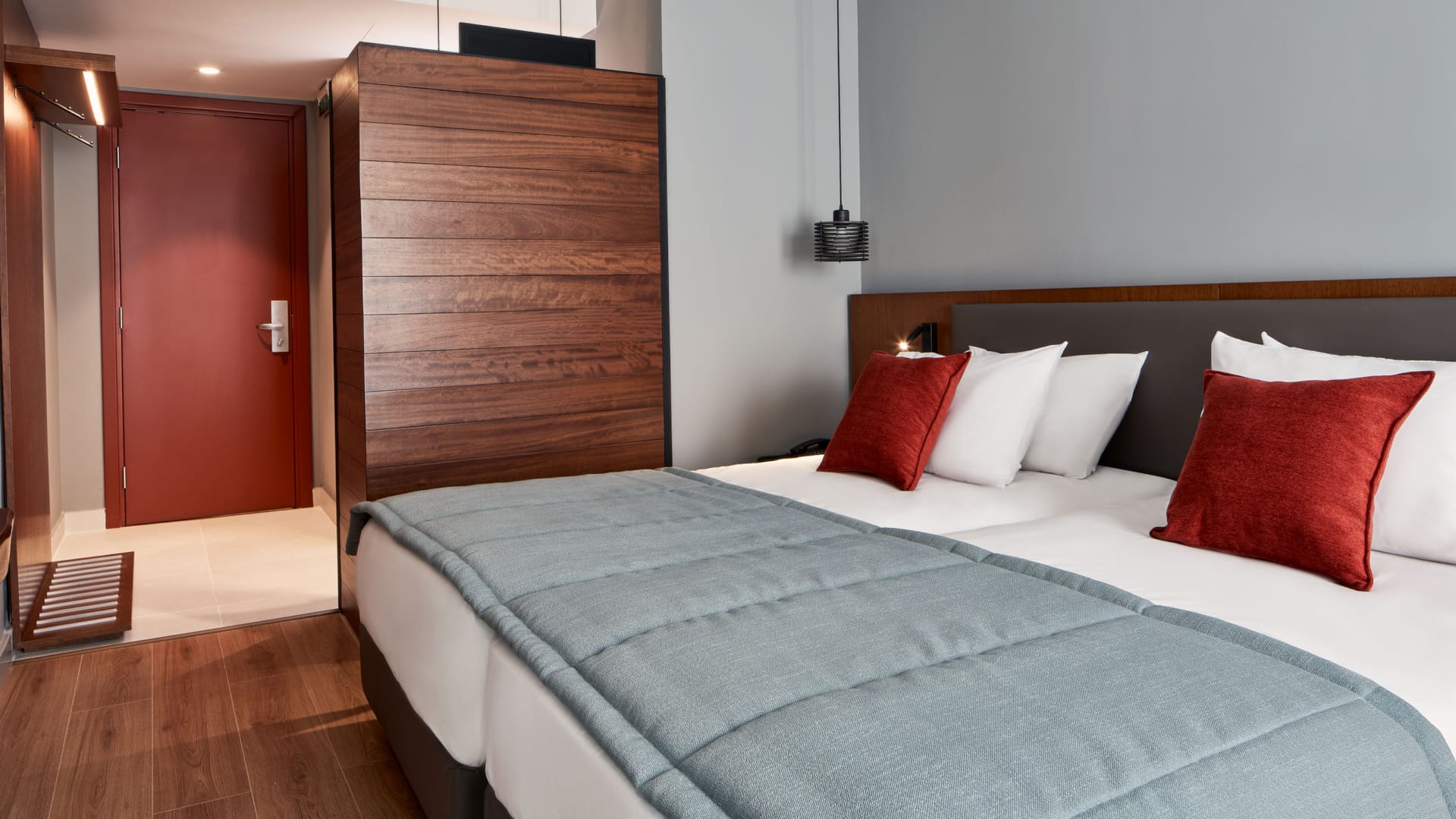 a bed with red pillows